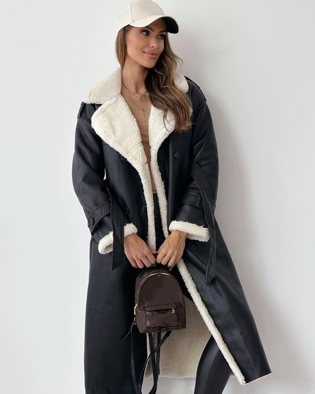 Woman in a belted faux shearling coat