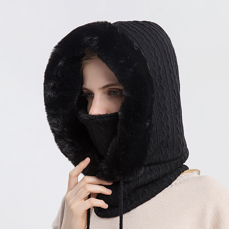 Woman wearing knit hood with faux fur trim