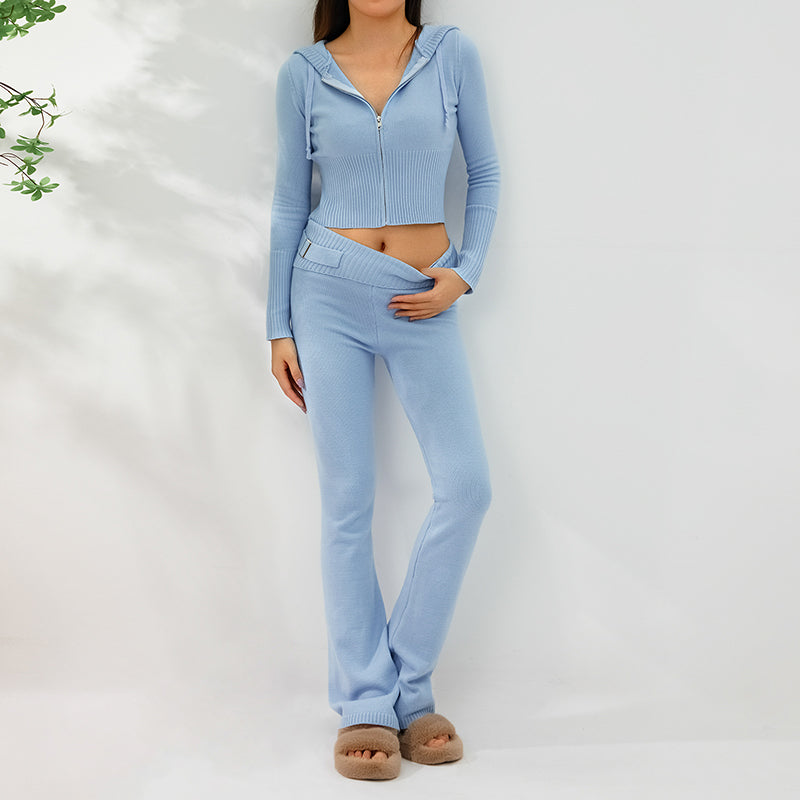 Woman in ribbed knit hoodie and flare pants set