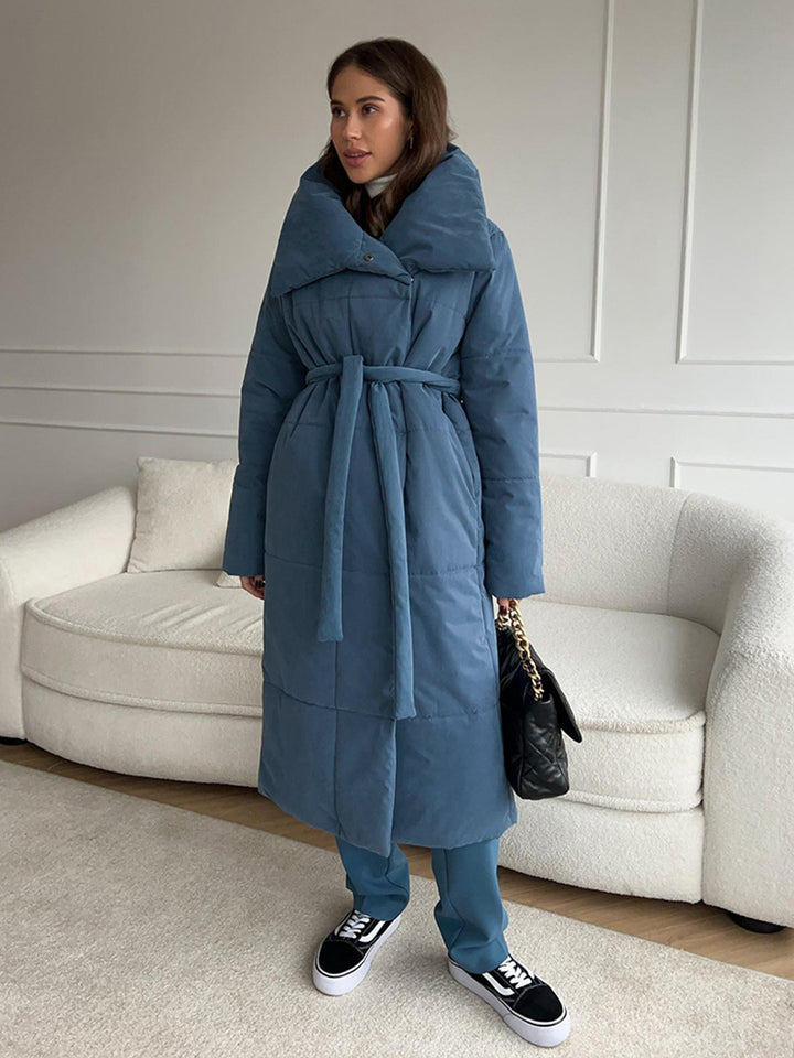 Woman in a long quilted belted coat