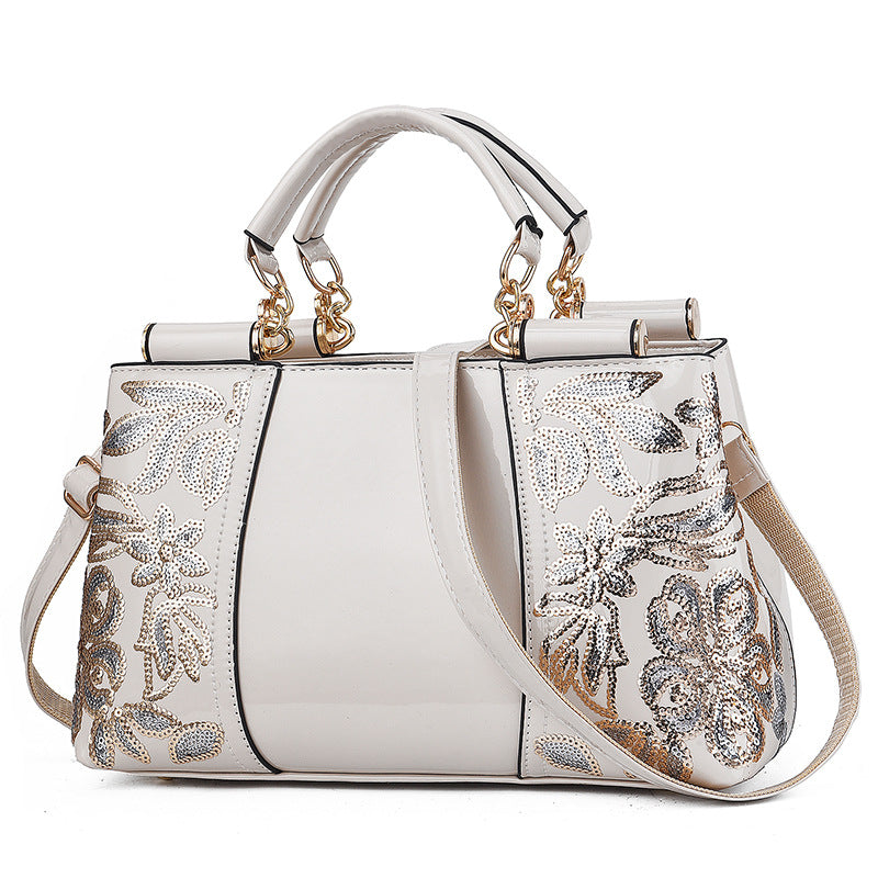 Sequin embroidered patent leather handbag