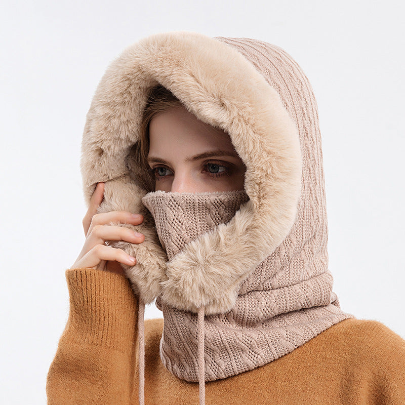 Woman wearing knit hood with faux fur trim