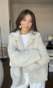 Woman in a short off-white teddy jacket