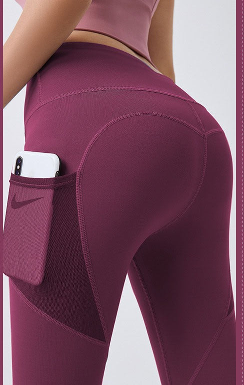 Woman wearing black high-waist leggings with phone pocket