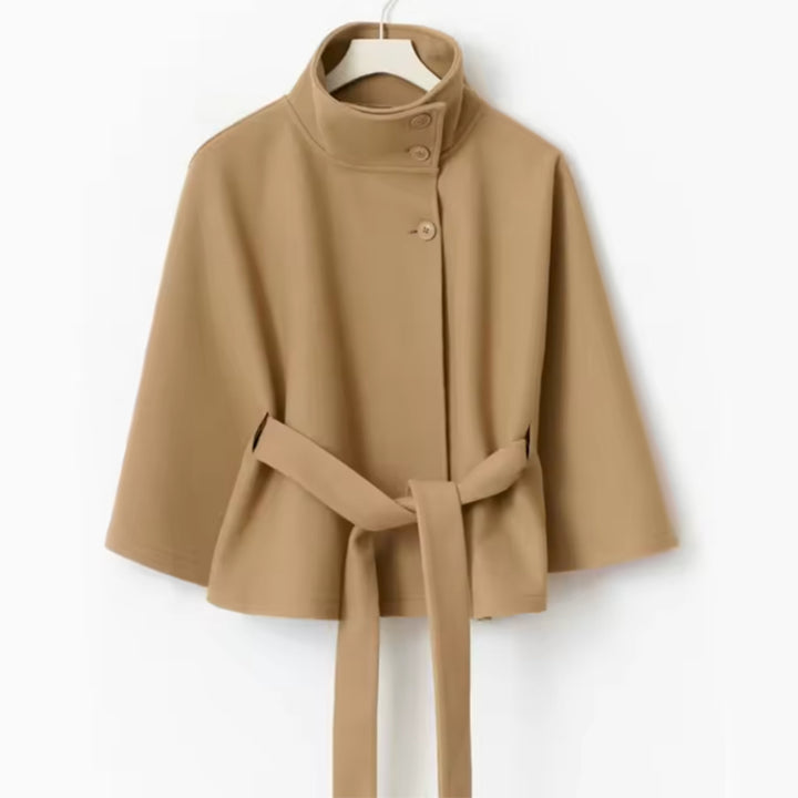 Woman in belted cape coat with high collar