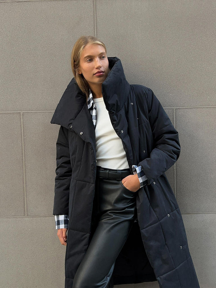 Woman in a long quilted belted coat