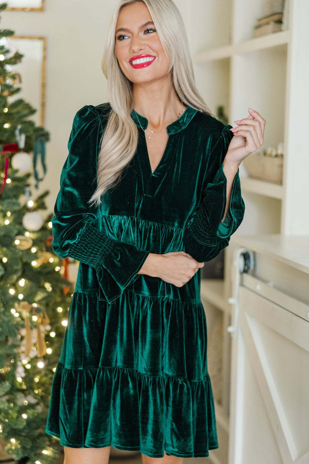 Woman in a green velvet mini dress