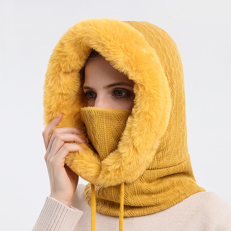Woman wearing knit hood with faux fur trim