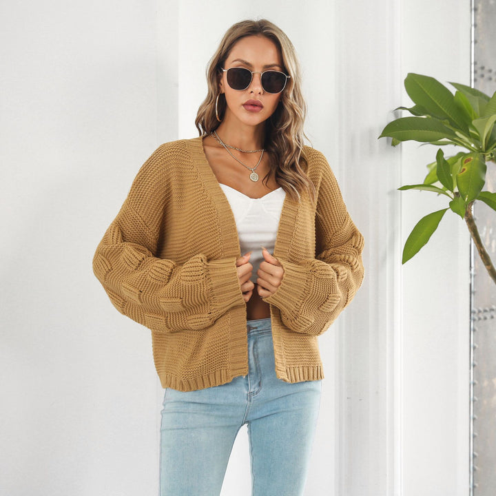 Woman in chunky cable knit puff sleeve cardigan